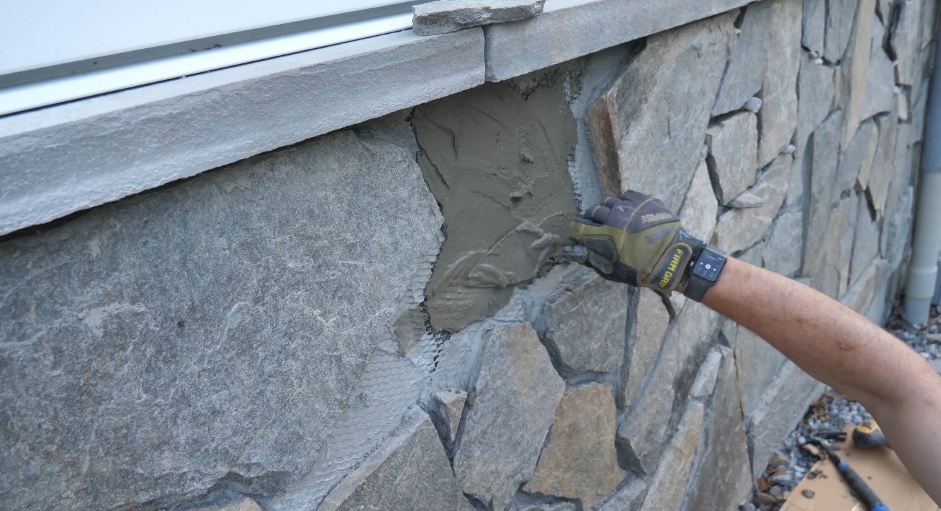 Stone veneer siding installation on home exterior